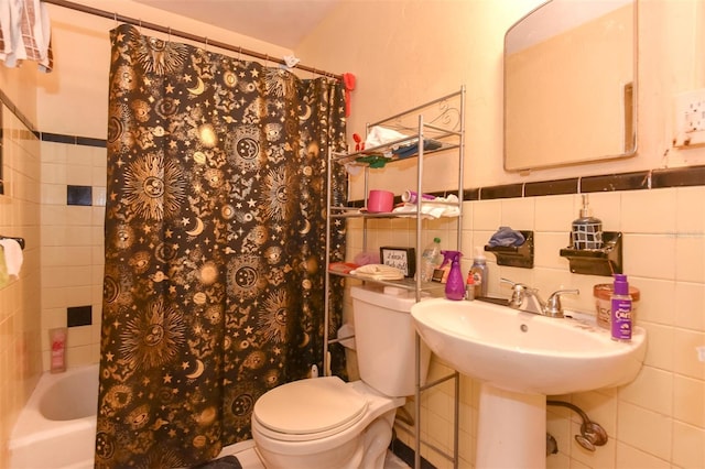 bathroom with shower / bathtub combination with curtain, tile walls, and toilet