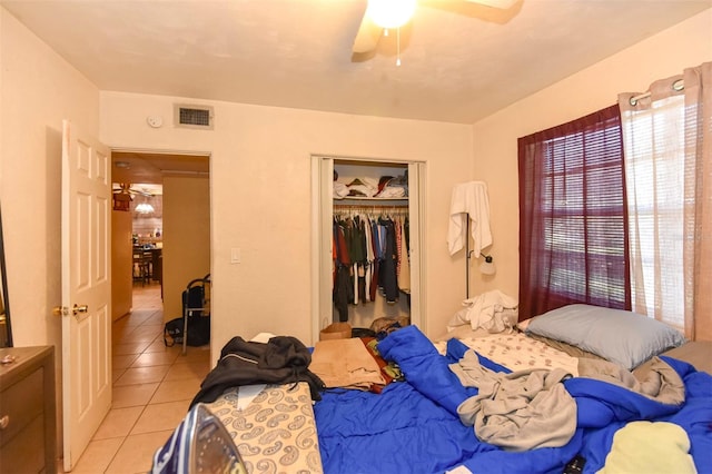 tiled bedroom with a closet and ceiling fan