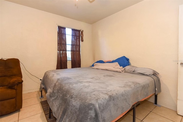 tiled bedroom with ceiling fan