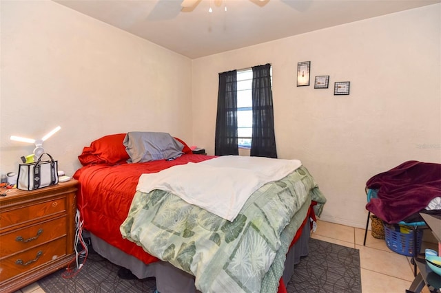 tiled bedroom featuring ceiling fan