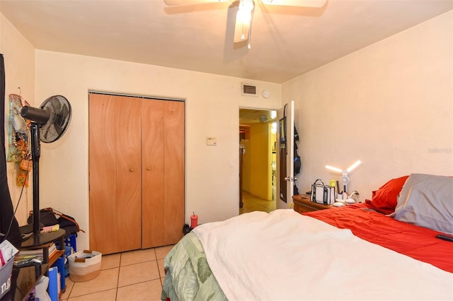 tiled bedroom featuring a closet and ceiling fan