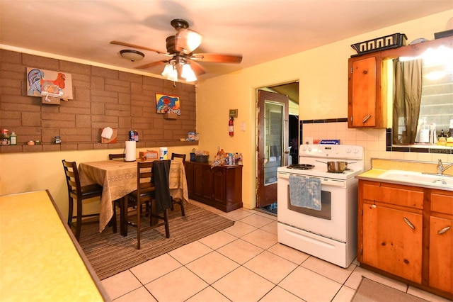 kitchen with tasteful backsplash, ceiling fan, sink, light tile patterned floors, and white electric stove