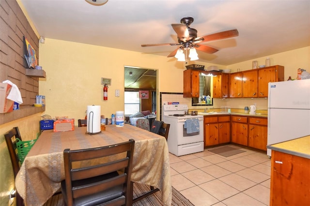 kitchen with backsplash, white appliances, ceiling fan, sink, and light tile patterned floors