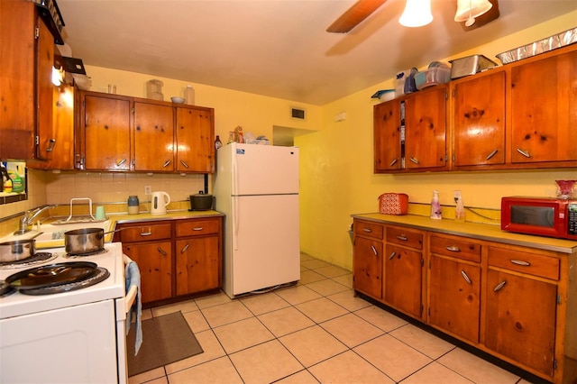 kitchen with backsplash, ceiling fan, light tile patterned floors, and white appliances