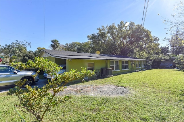 view of property exterior featuring a lawn and central air condition unit