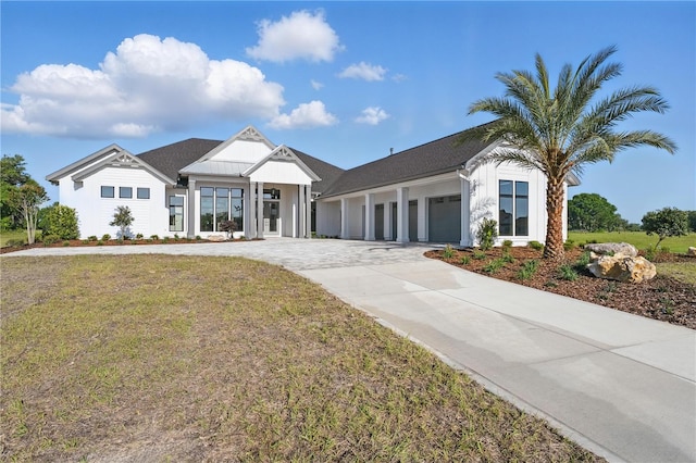 5040 SW 125th Cir, Archer, FL 32618 - modern farmhouse with an attached garage, concrete driveway, and a front lawn