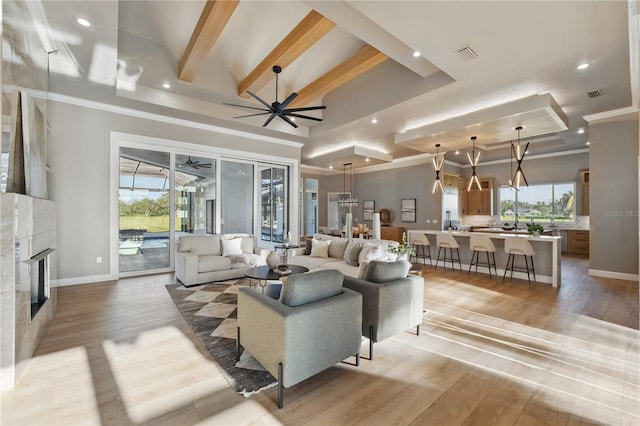 5040 SW 125th Cir, Archer, FL 32618 - living room with a fireplace, light wood finished floors, plenty of natural light, crown molding, and recessed lighting
