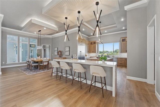 5040 SW 125th Cir, Archer, FL 32618 - kitchen with a breakfast bar area, light countertops, ornamental molding, recessed lighting, and stainless steel built in refrigerator