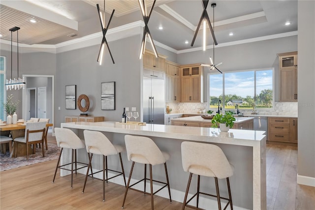 5040 SW 125th Cir, Archer, FL 32618 - kitchen with a towering ceiling, a large island, a kitchen bar, backsplash, and glass insert cabinets