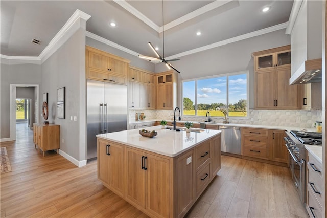 5040 SW 125th Cir, Archer, FL 32618 - kitchen with premium appliances, healthy amount of natural light, a center island with sink, light countertops, and crown molding