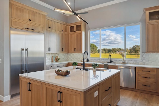 5040 SW 125th Cir, Archer, FL 32618 - kitchen featuring stainless steel appliances, ornamental molding, glass insert cabinets, light wood-style floors, and a ceiling fan