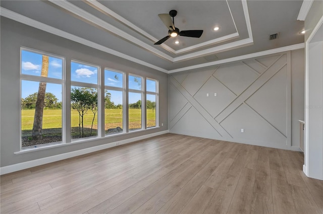 5040 SW 125th Cir, Archer, FL 32618 - spare room featuring a decorative wall, a tray ceiling, crown molding, light wood finished floors, and a ceiling fan