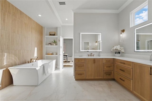 5040 SW 125th Cir, Archer, FL 32618 - full bath featuring a freestanding bath, vanity, crown molding, built in features, and marble look tiles