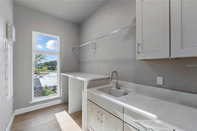 5040 SW 125th Cir, Archer, FL 32618 - laundry room featuring a sink and light wood finished floors