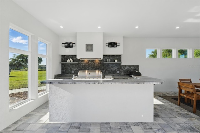 5040 SW 125th Cir, Archer, FL 32618 - kitchen featuring a center island, decorative backsplash, recessed lighting, and light countertops