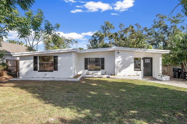 rear view of house featuring a yard