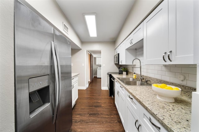 kitchen with dark hardwood / wood-style flooring, white cabinetry, sink, and appliances with stainless steel finishes