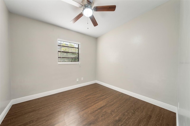 spare room with ceiling fan and dark wood-type flooring