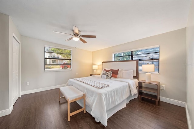 bedroom with dark hardwood / wood-style flooring, a closet, and ceiling fan