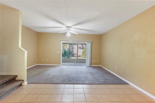 unfurnished room with light colored carpet and ceiling fan