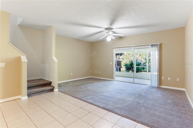 interior space featuring light carpet and ceiling fan