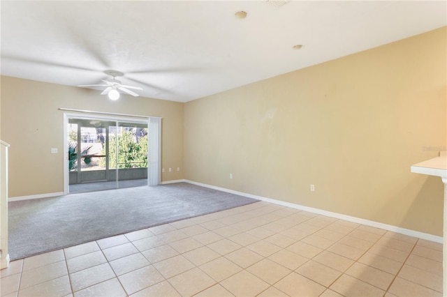 empty room with light colored carpet and ceiling fan