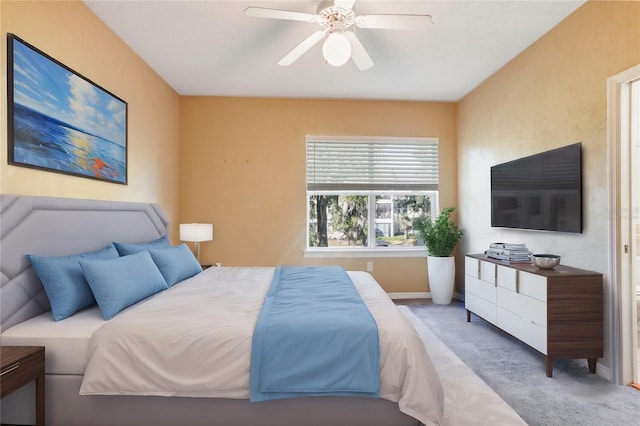 bedroom with light colored carpet and ceiling fan