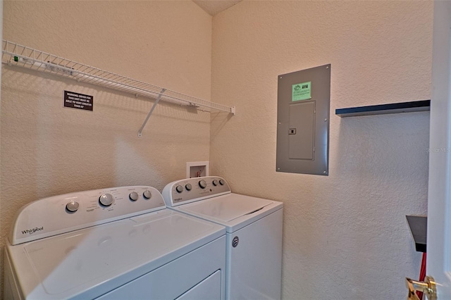 clothes washing area featuring washing machine and dryer and electric panel