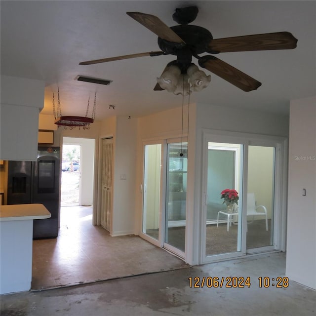 interior space with ceiling fan and concrete floors