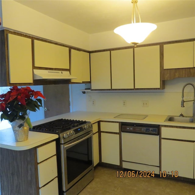 kitchen featuring light tile patterned floors, sink, white dishwasher, and stainless steel range with gas stovetop