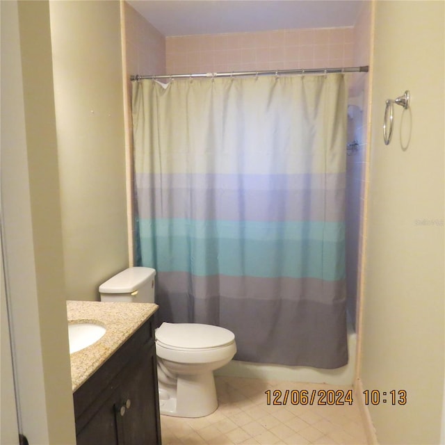 bathroom with tile patterned floors, vanity, and toilet