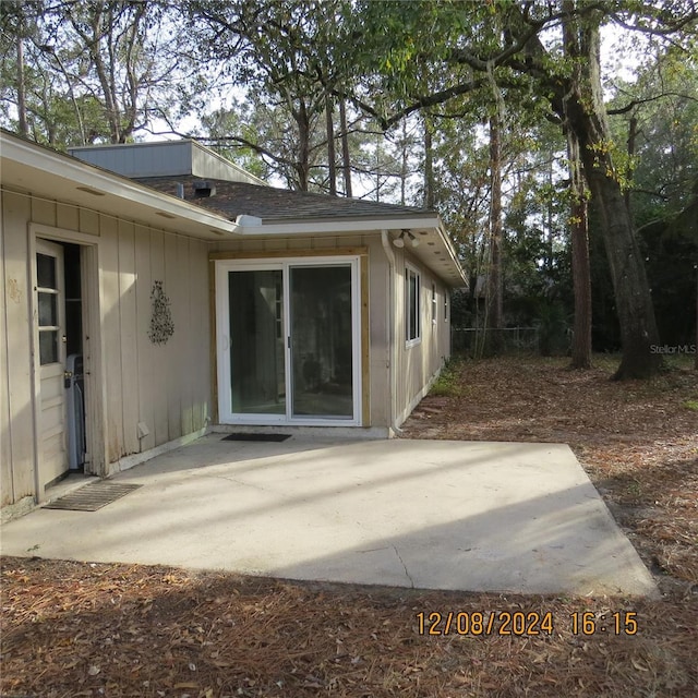 view of side of property with a patio