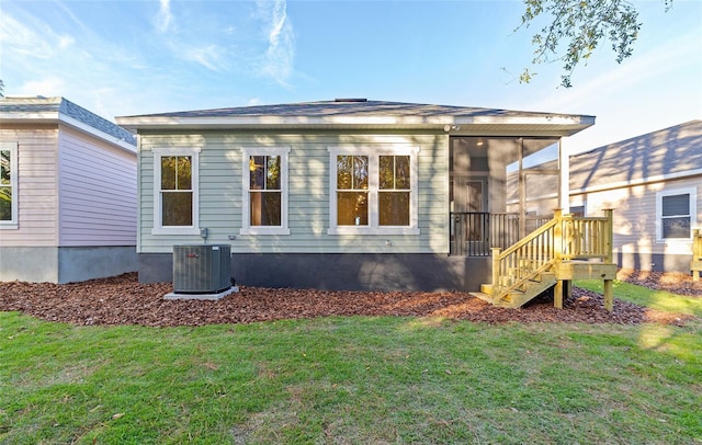 view of side of home featuring a yard, cooling unit, and a sunroom