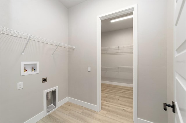 laundry room with electric dryer hookup, washer hookup, and light wood-type flooring