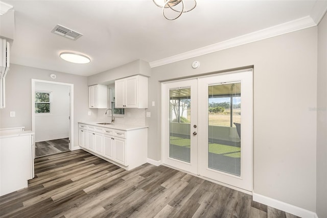 kitchen featuring white cabinetry, sink, crown molding, and dark hardwood / wood-style floors