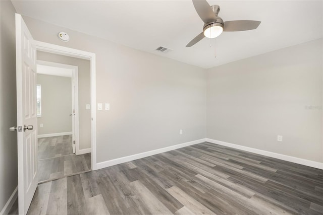 empty room with ceiling fan and hardwood / wood-style flooring