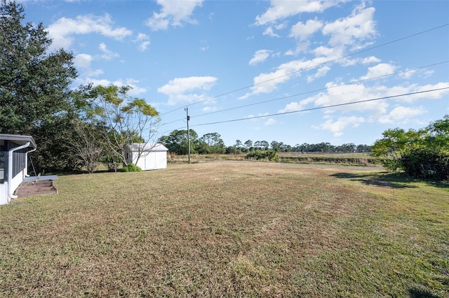 view of yard with a rural view