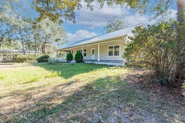 view of front of home featuring covered porch and a front yard