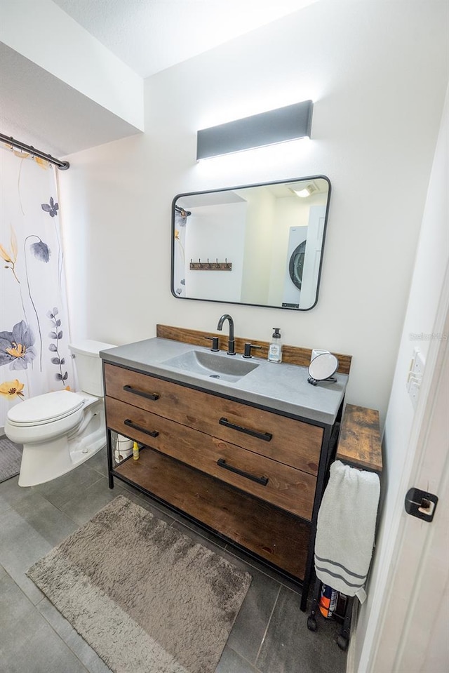 bathroom featuring toilet, vanity, and walk in shower