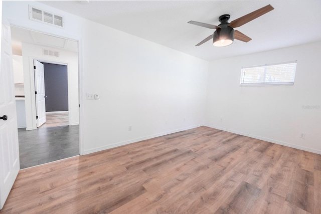 empty room featuring ceiling fan and hardwood / wood-style floors