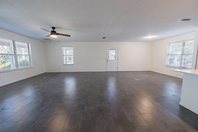 spare room featuring ceiling fan and a textured ceiling