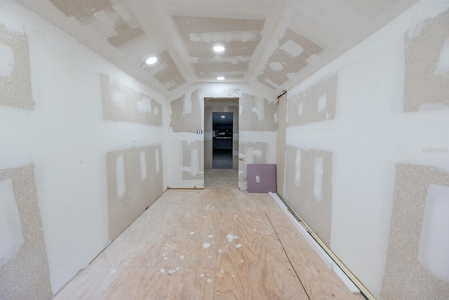 hallway featuring vaulted ceiling