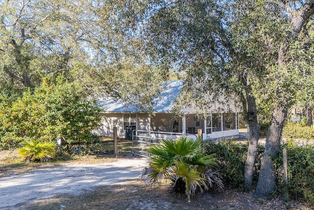 obstructed view of property featuring a sunroom