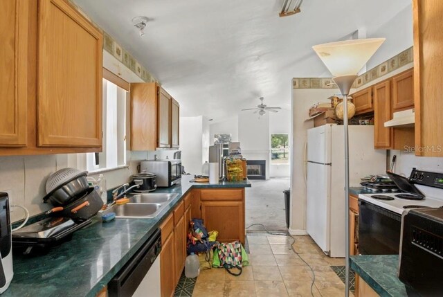 kitchen featuring white appliances, ceiling fan, sink, light tile patterned floors, and lofted ceiling