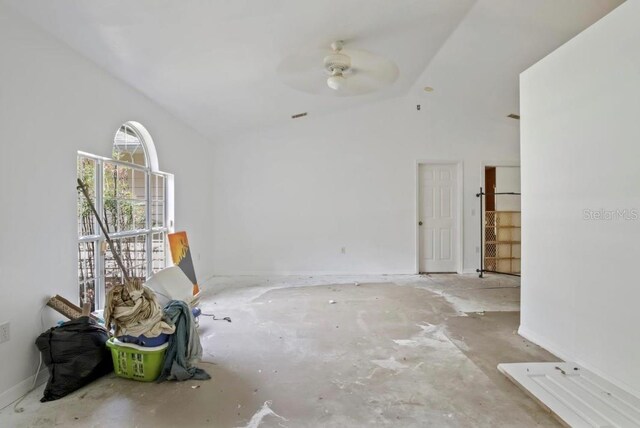 empty room with ceiling fan and lofted ceiling