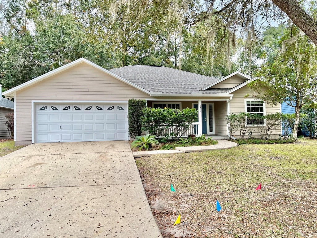 single story home featuring a porch and a garage