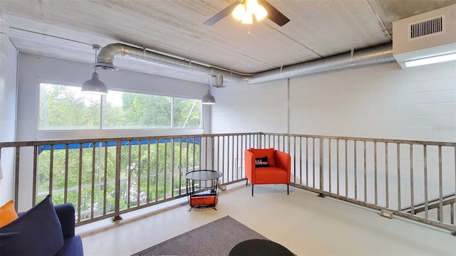 interior space with concrete flooring and ceiling fan