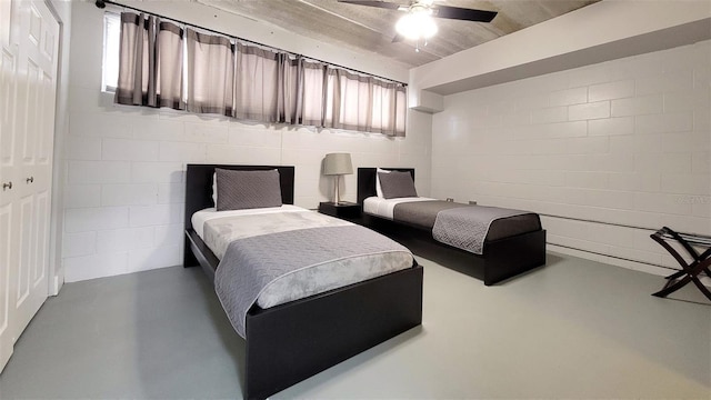 bedroom with concrete flooring, a closet, and ceiling fan