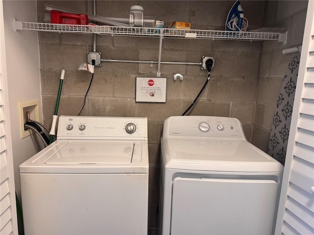 clothes washing area featuring separate washer and dryer