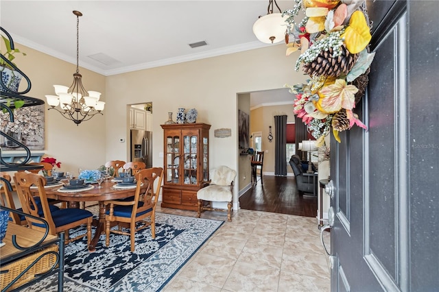 tiled dining room featuring a chandelier and crown molding